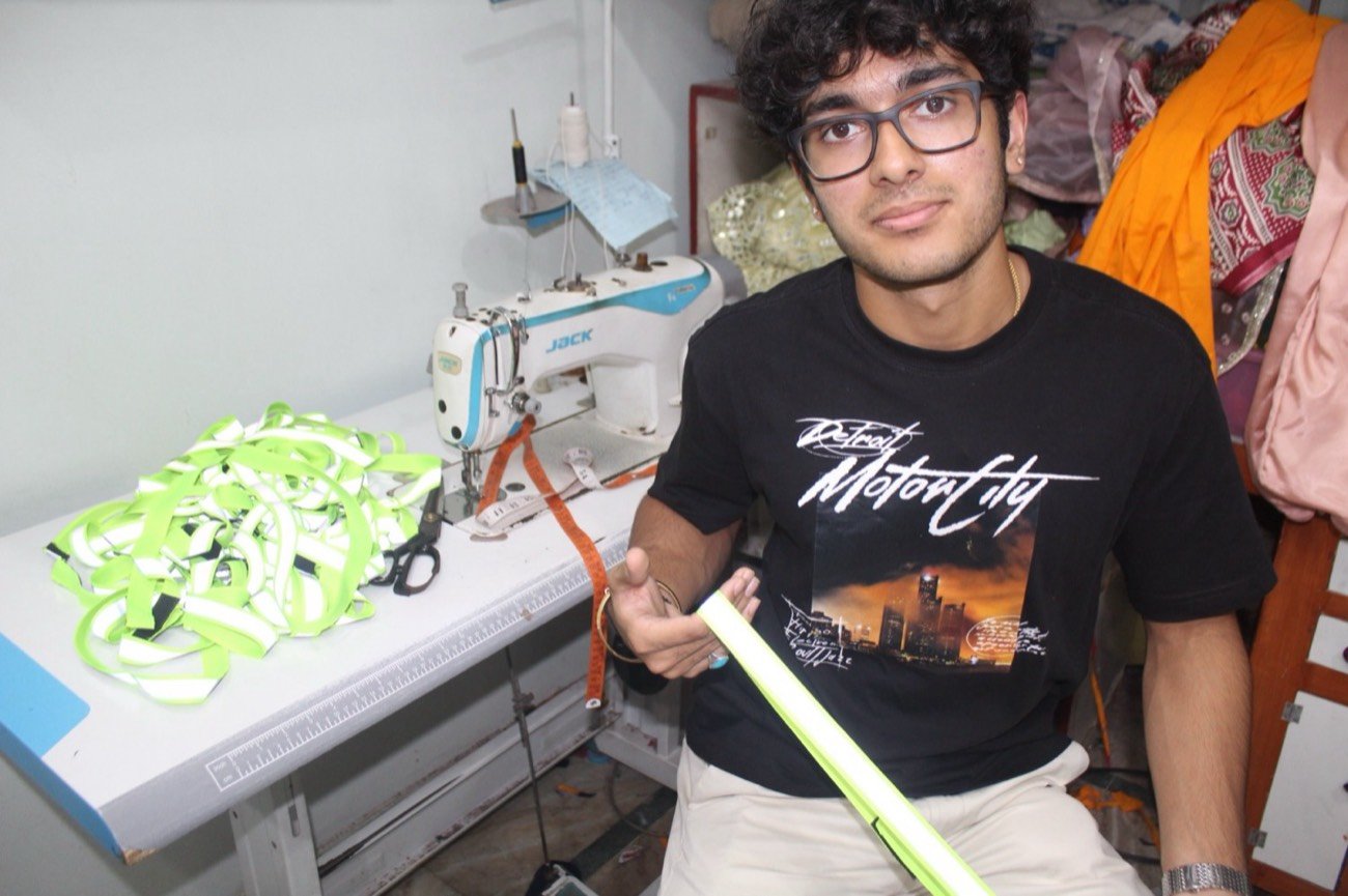 Siddharth Sharma working at the sewing machine on collar production